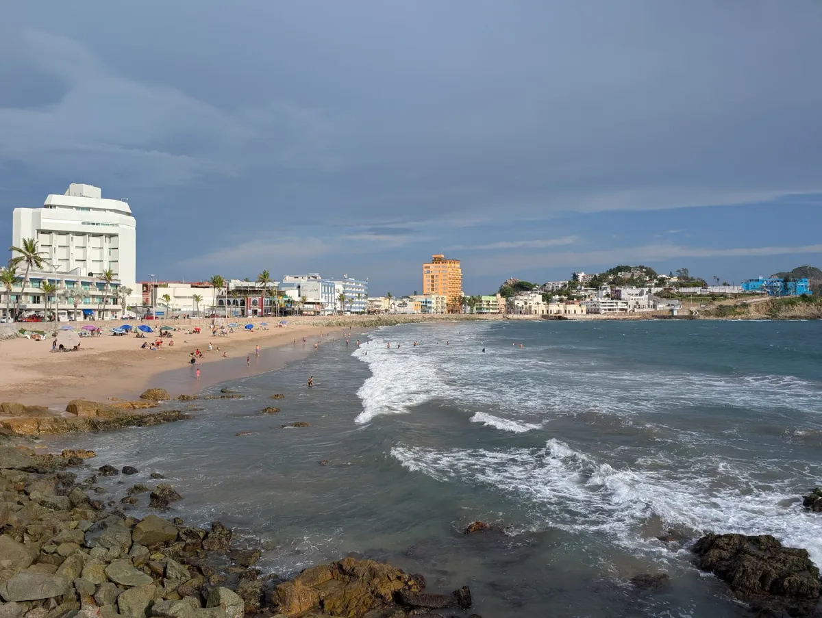 The beach and waterfront in Mazatlán under a stormy sky